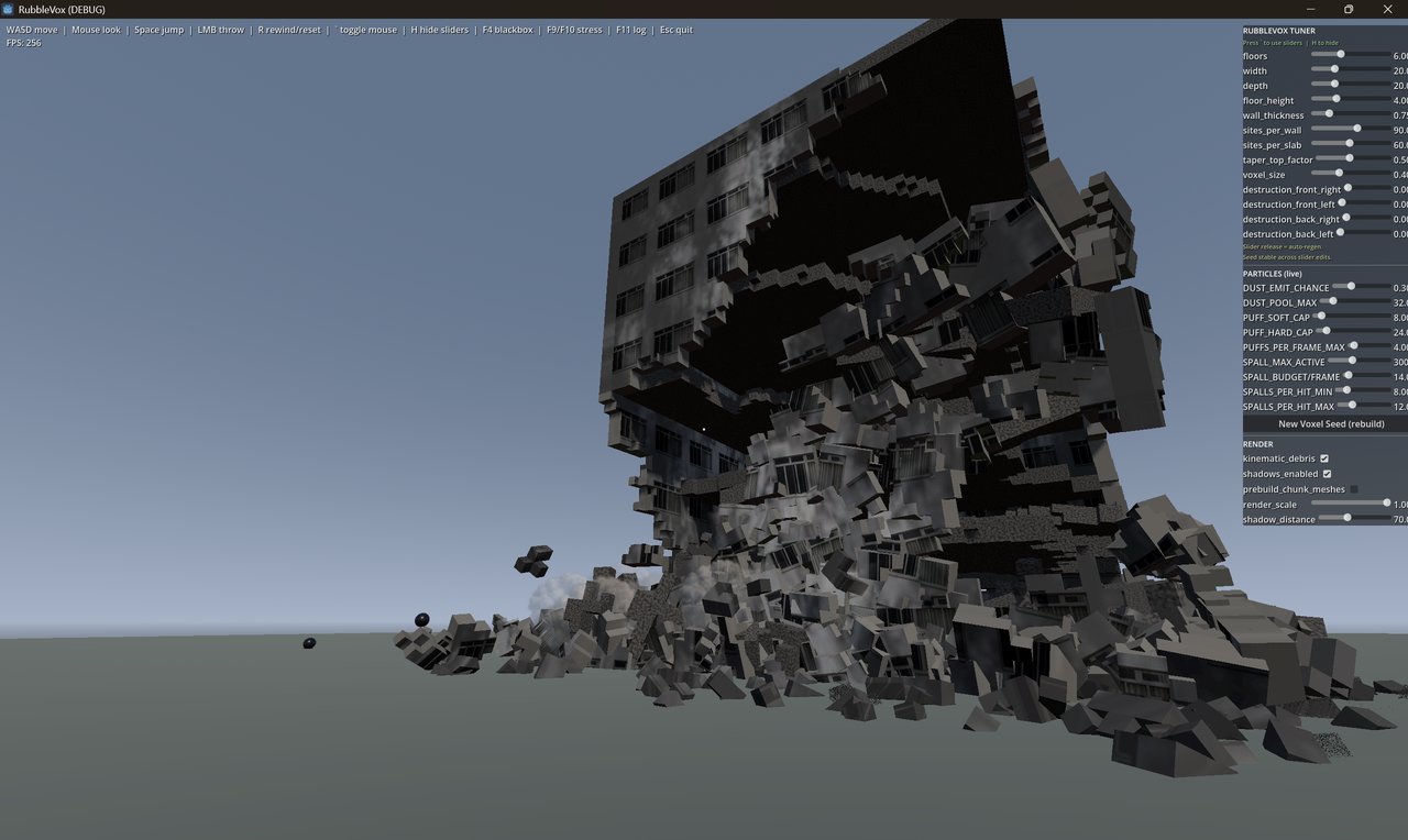A grey building simulation nearing complete destruction, with most of its structure collapsed into a pile of rubble and 
